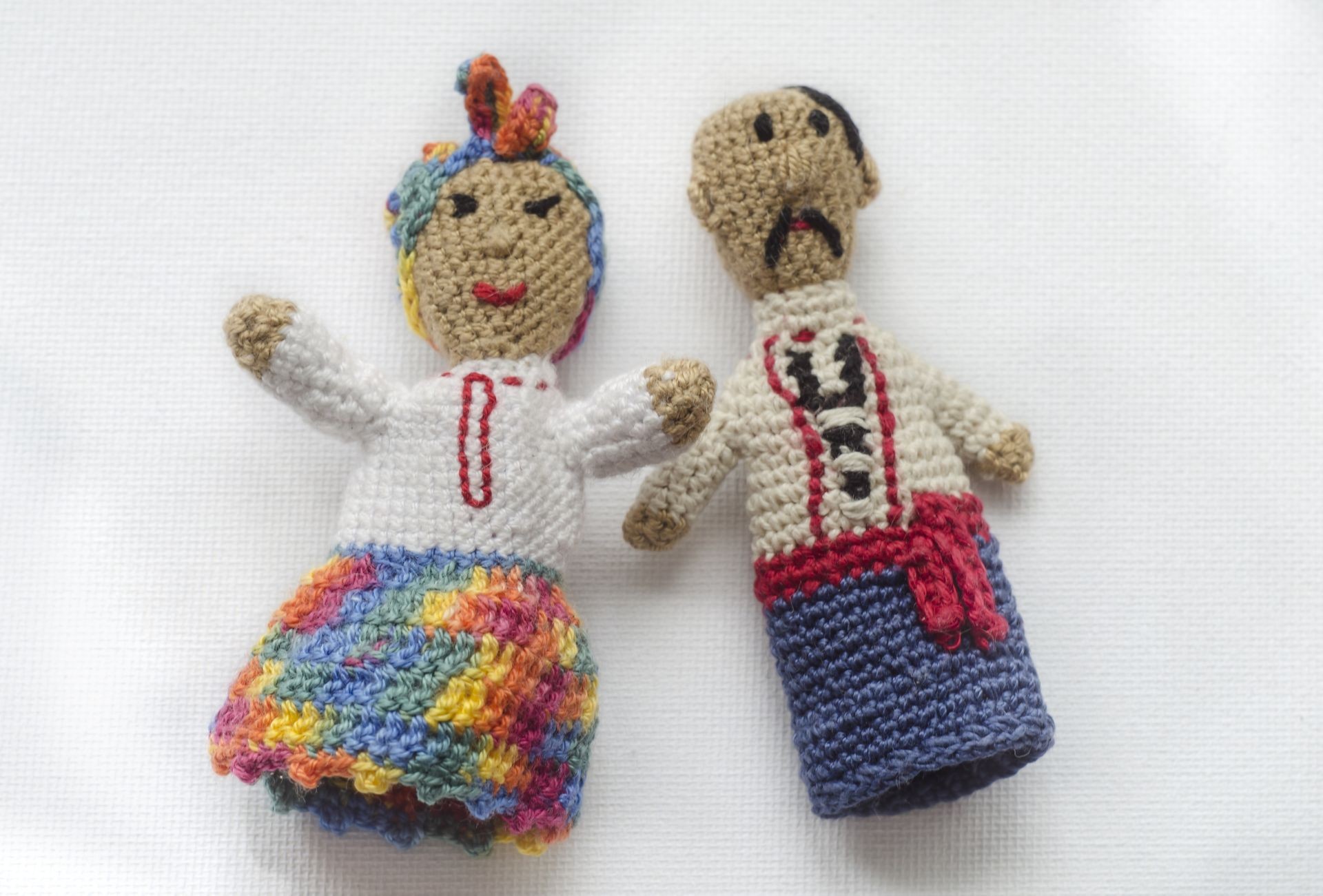 Finger puppets knitted from wool. Hand made. Knitted toys. man and woman in Ukrainian national costumes. Finger theater.